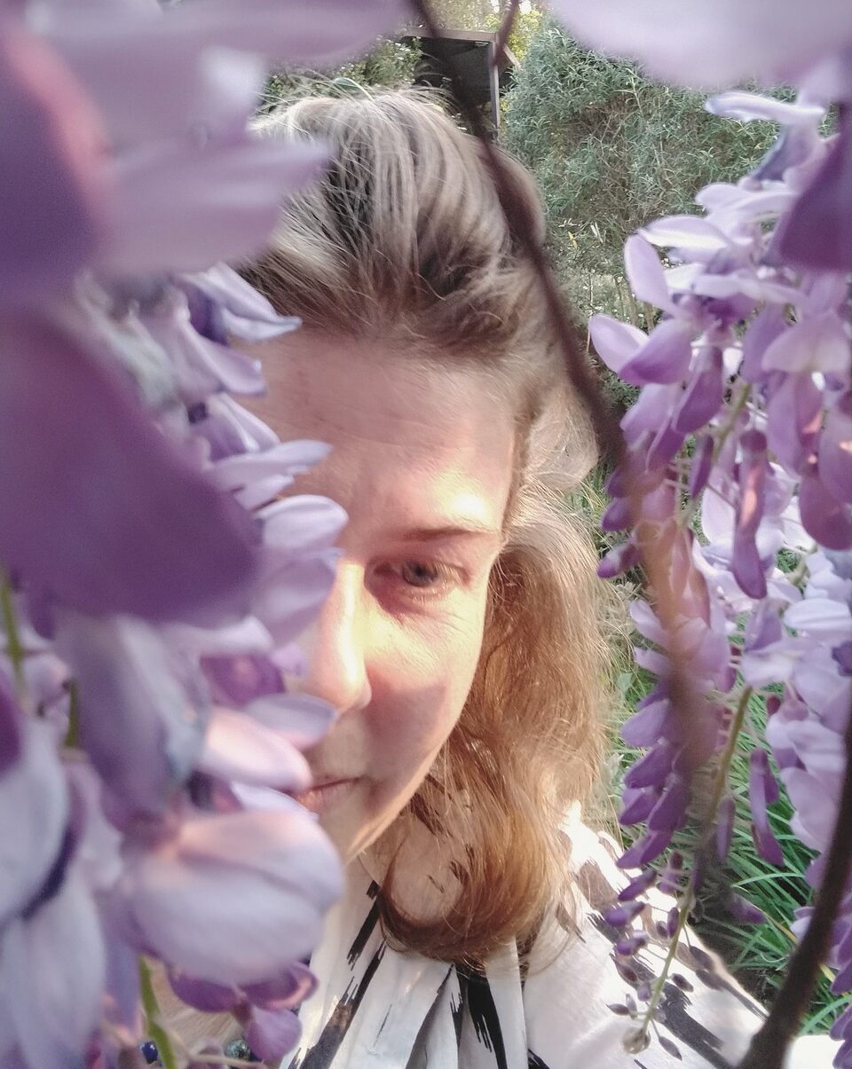 Elizabeth, framed by wisteria in flower